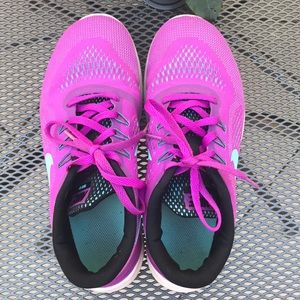 Beautiful bright purple girls Nike running shoes